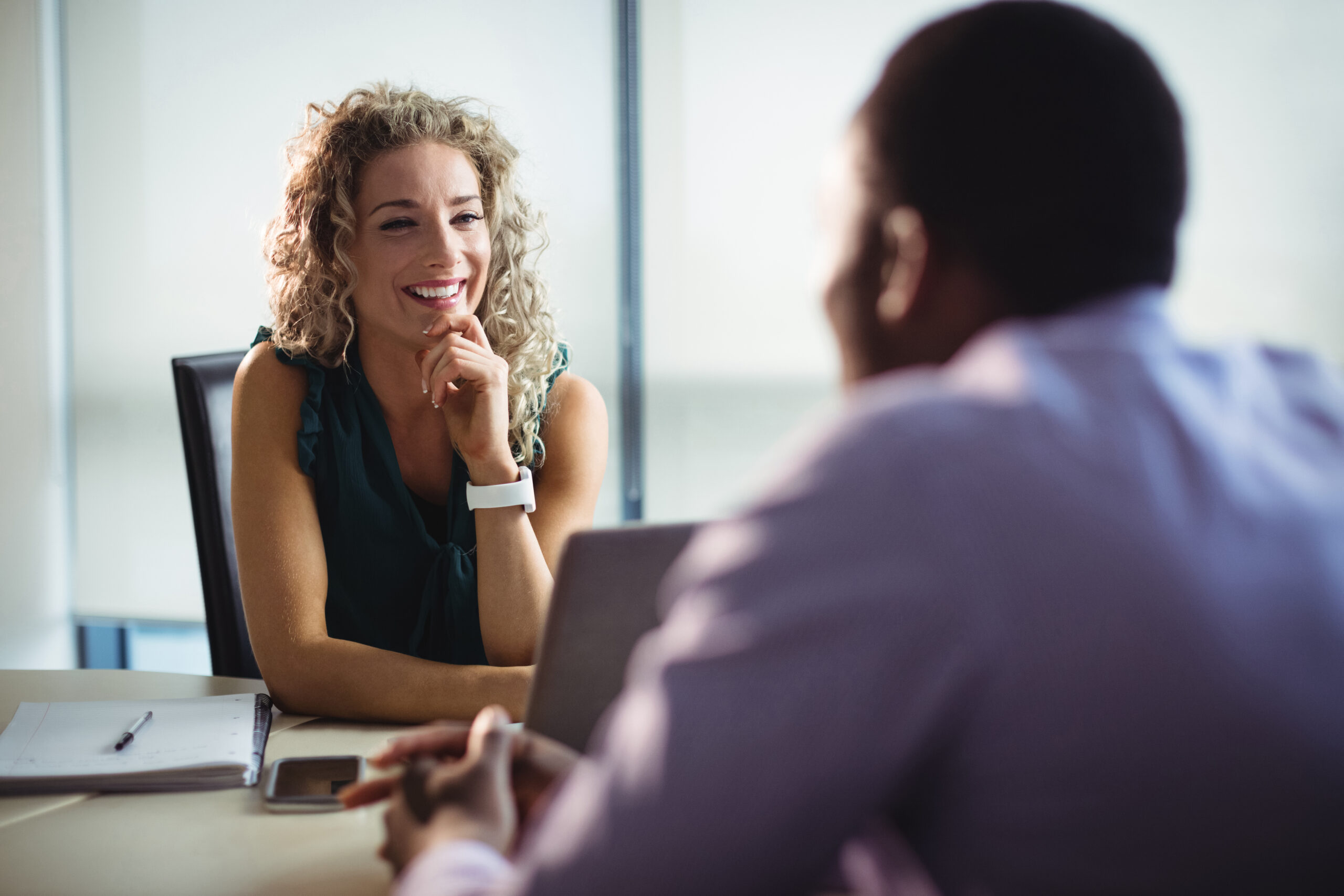 Business executives interacting with each other in office