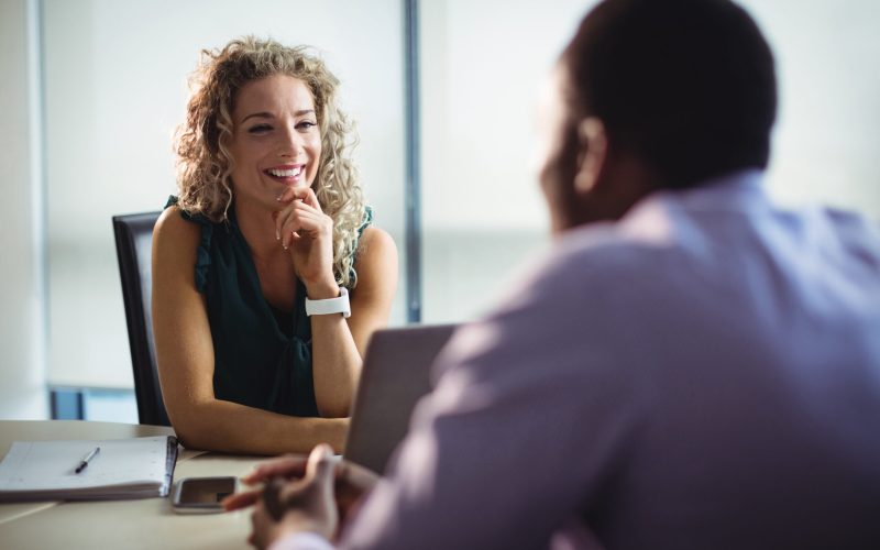 Business executives interacting with each other in office