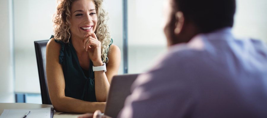 Business executives interacting with each other in office